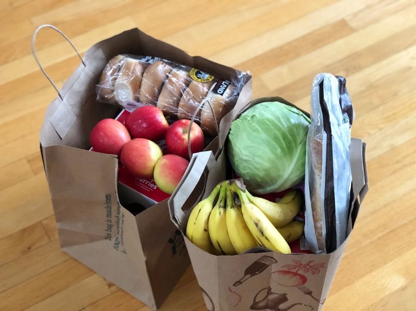 Grocery Shopping - apples and bananas in brown cardboard box