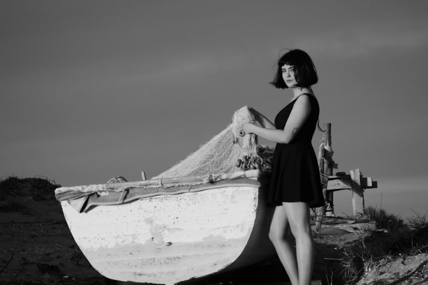 Little Black Dress - grayscale photo of woman holding fish net