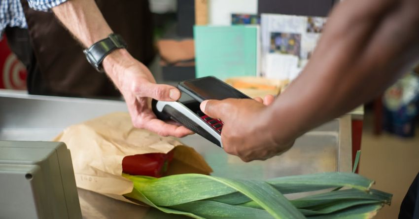 Groceries Online - A Customer Paying for Groceries Using a Smartphone