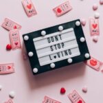 Coupon Deals - A Letterboard on Pink Surface Surrounded with Pink Tickets