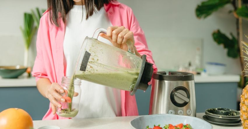 Blenders - Woman Makes Green Smoothie