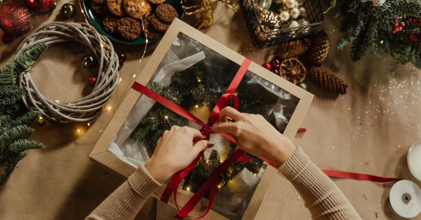 Gift - Top View of Woman Packing a Christmas Present